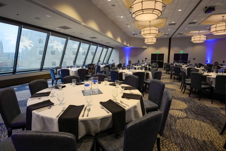 Banquet hall with round tables and modern interior lighting